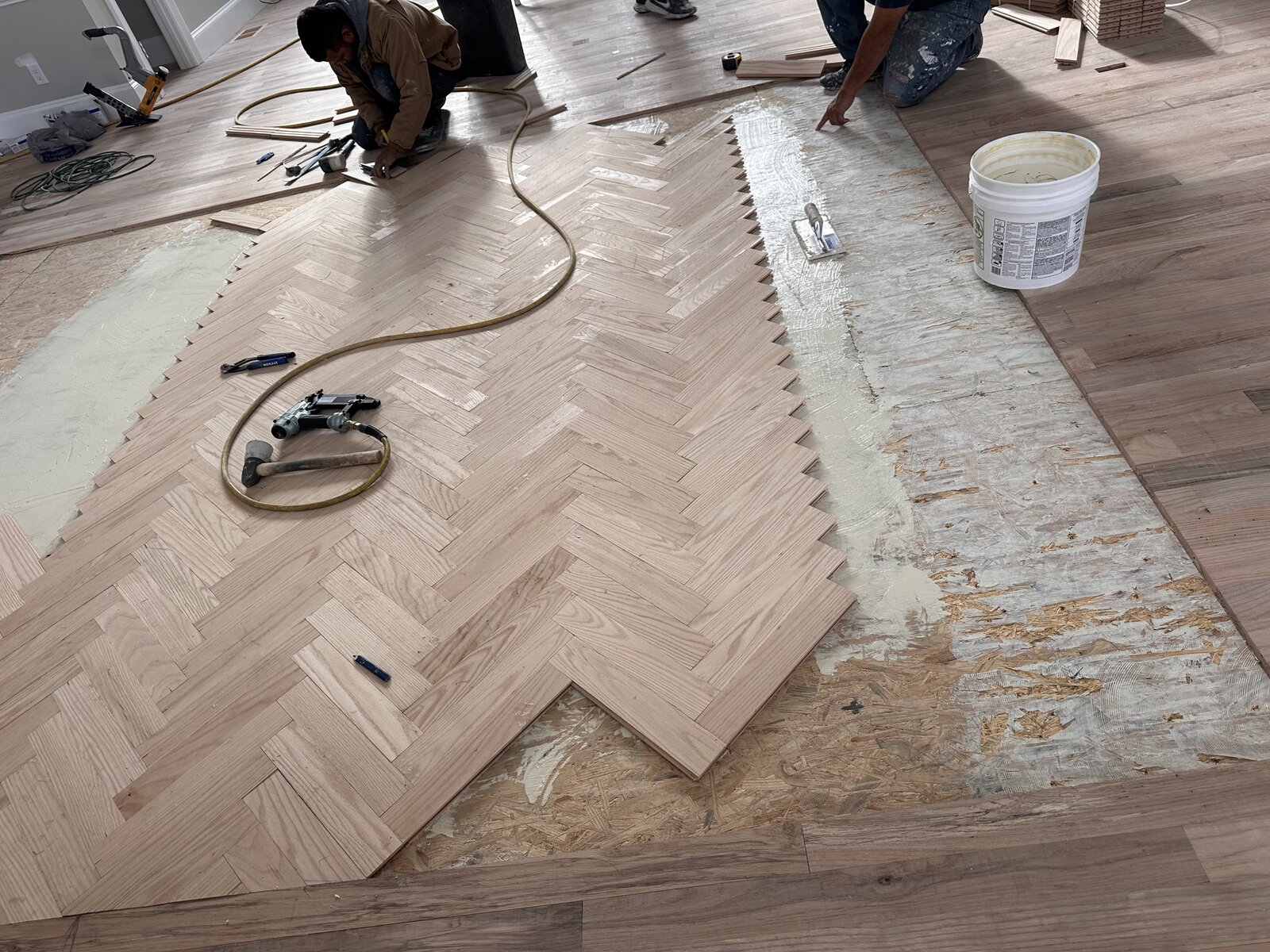 Before: craftsmen precision-fitting herringbone planks