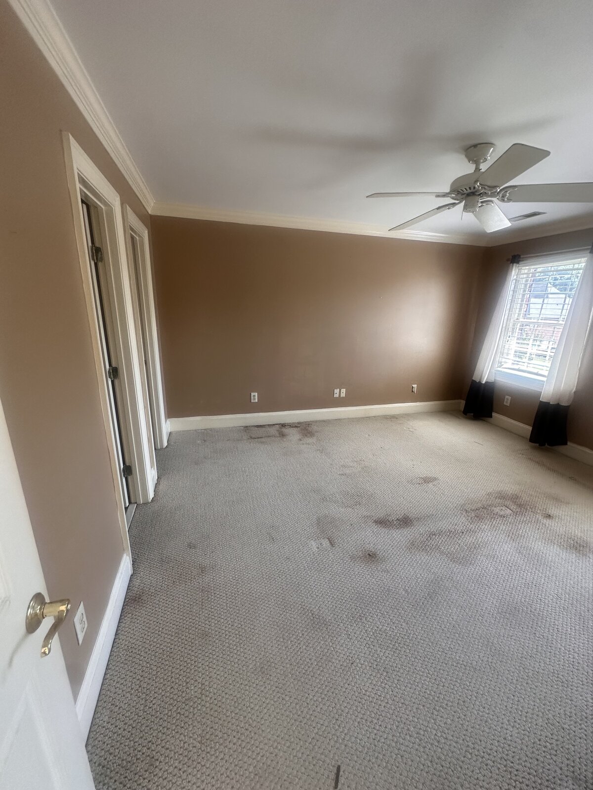 Before: master bedroom with worn carpet needing renovation