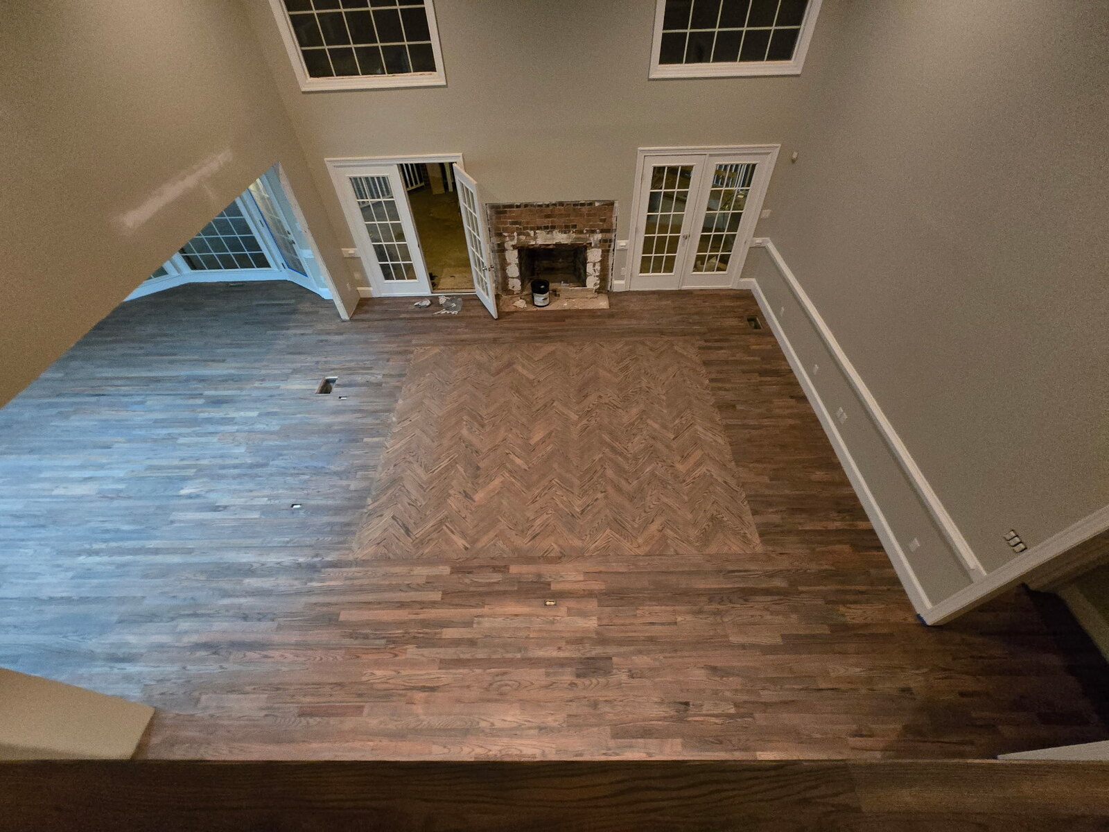 Finished: great room with fully stained herringbone inset flooring