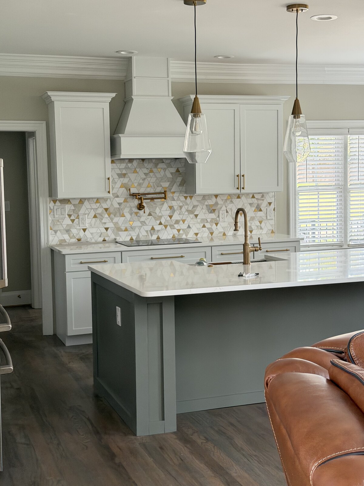 Glass-enclosed corner shower with white subway tile and marble surround