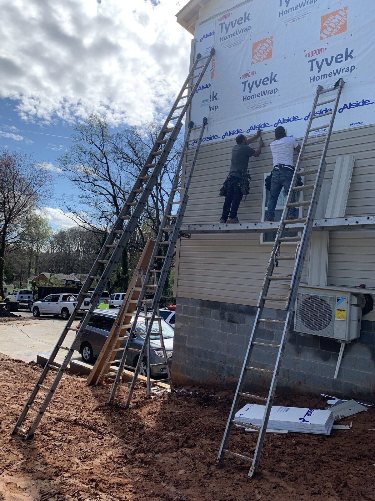 Before: exterior siding installation on a two-story home