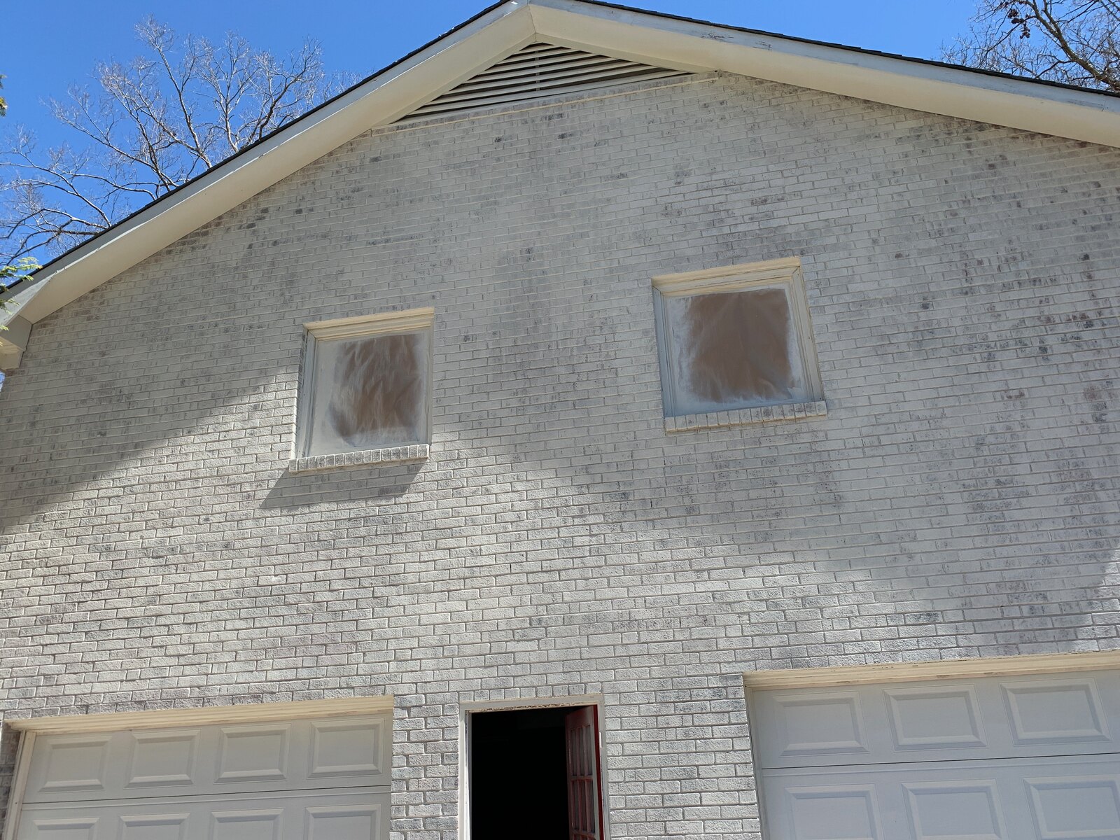 Before: weathered painted brick exterior in need of refinishing
