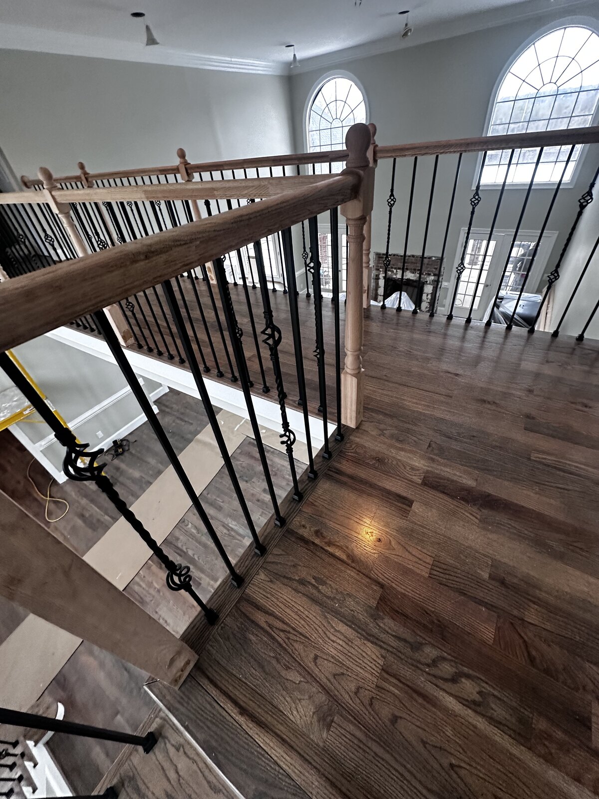 Before: foyer renovation — new staircase balusters and hardwood installed