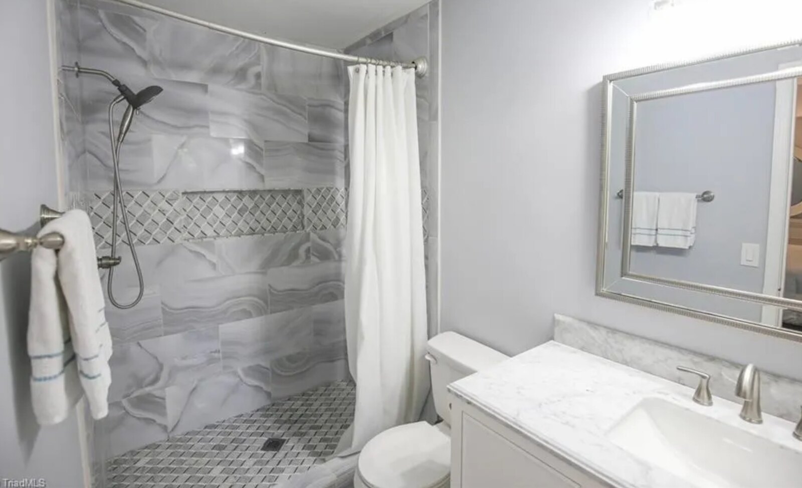 Master bathroom with marble swirl tile walk-in shower and diamond accent band