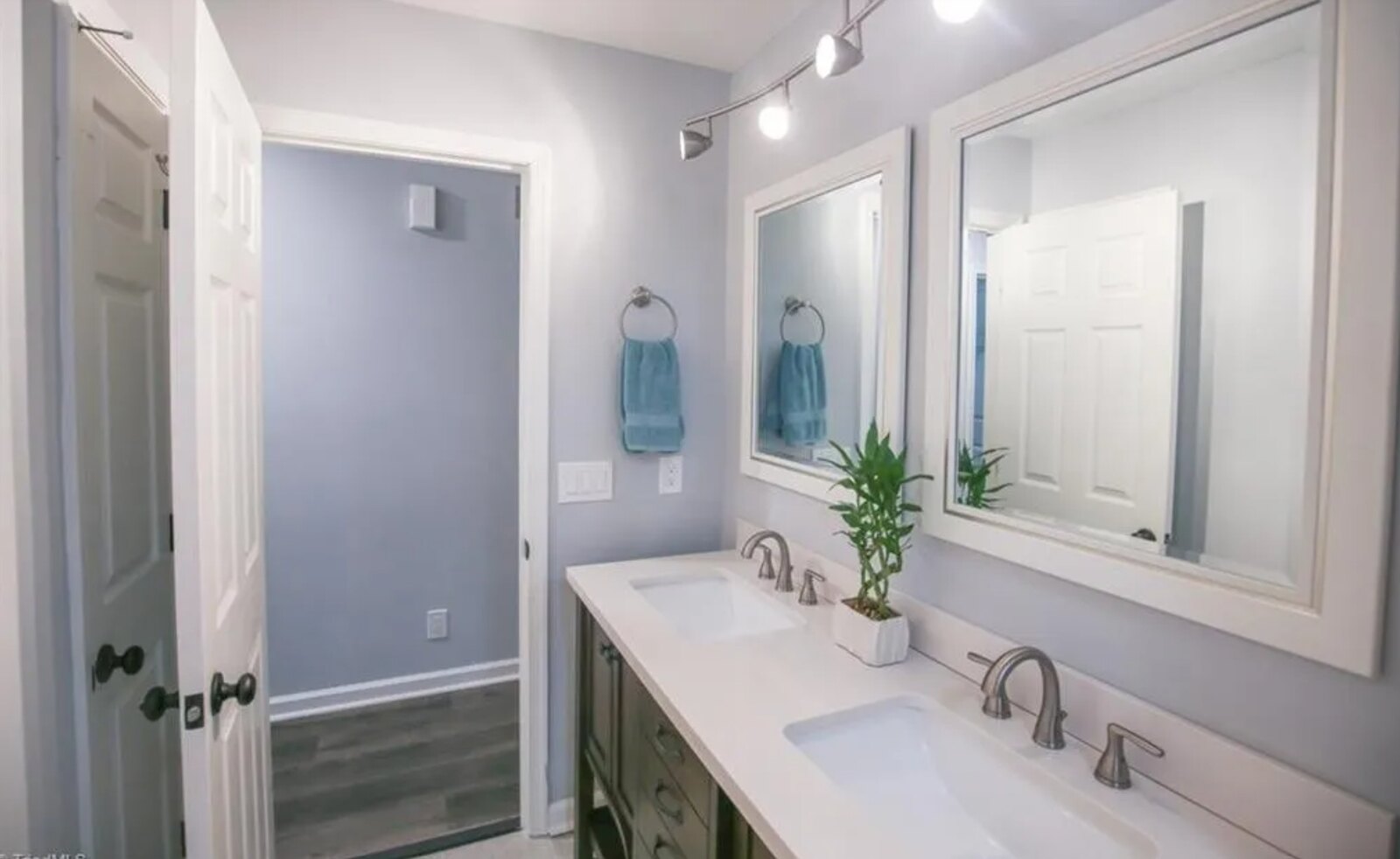 Bathroom with double vanity, framed mirrors and modern fixtures