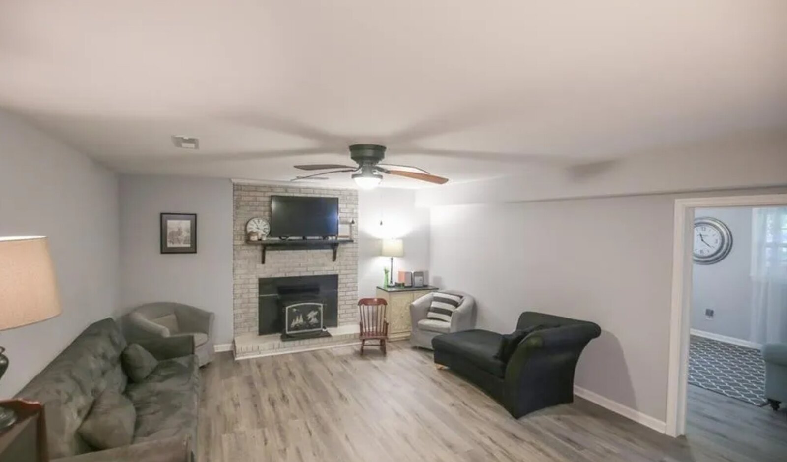 Cozy living room with brick fireplace, hardwood floors and open layout