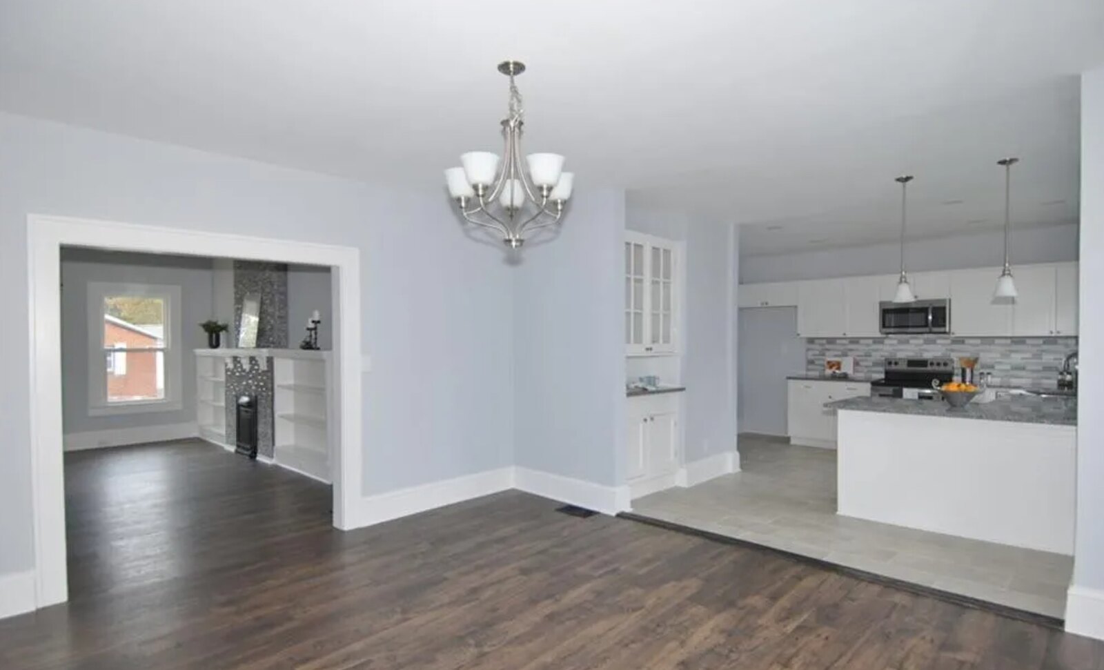Formal dining room with chandelier and rich hardwood flooring