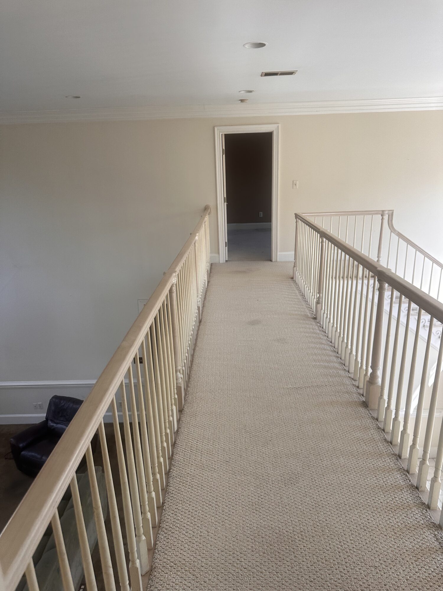 Finished: bridge walkway with stained hardwood and decorative iron balusters